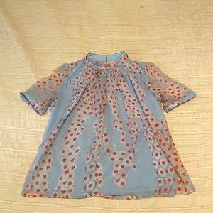 Soft blue with white flowers and red heart center blouse size small